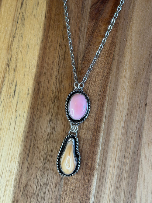 Made with high quality pink conch, elk ivory, and sterling silver. Hangs on an adjustable 16" stainless stell chain.  