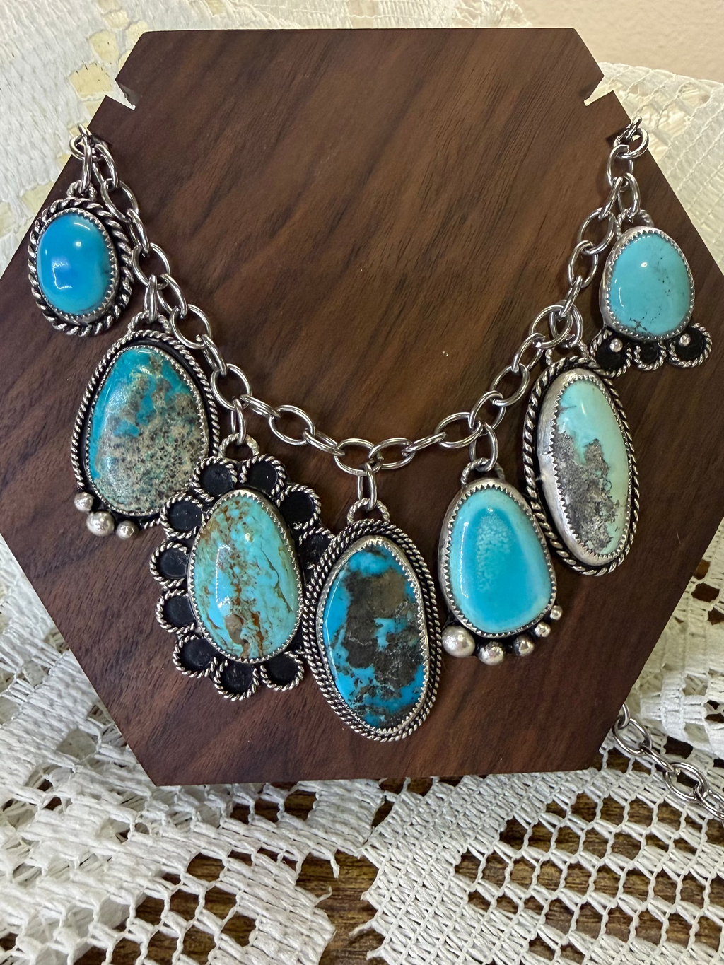 Necklace with turquoise stones on a wooden stand