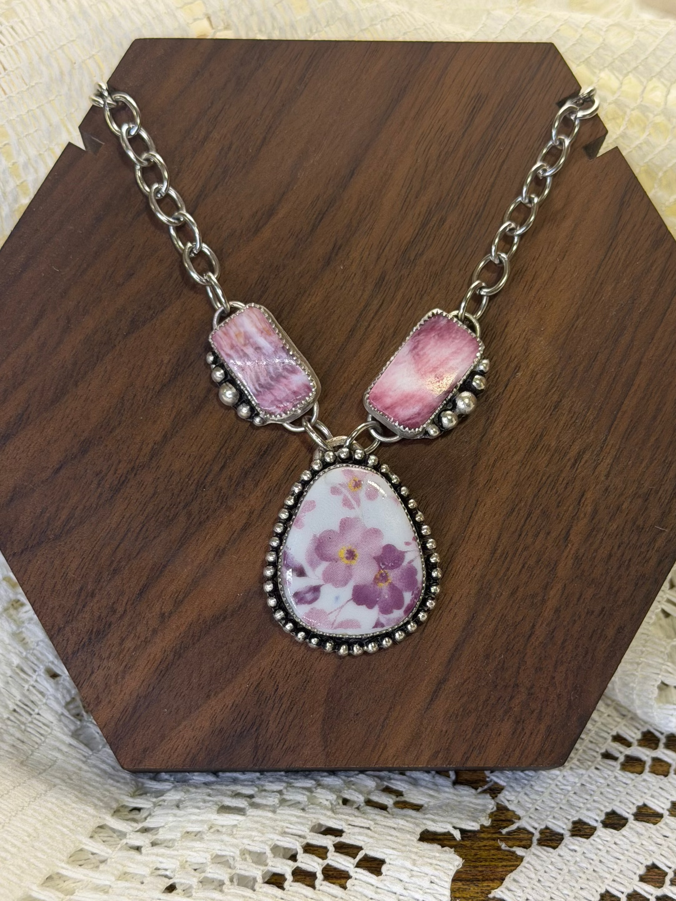 One of a kind necklace made with high quality purple spiny oyster and a purple floral ceramic tile. Hangs on an adjustable 16" stainless steel chain. 